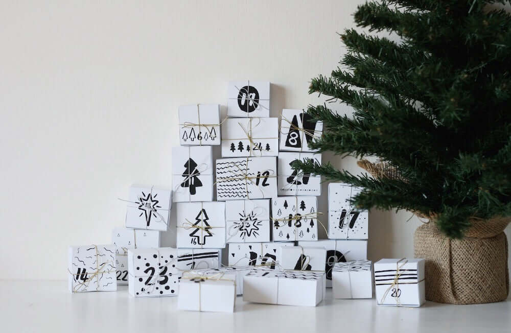DIY Advent Calendar Printable | Christmas Countdown Activity (PDF) with decorated gift boxes and a small evergreen tree.